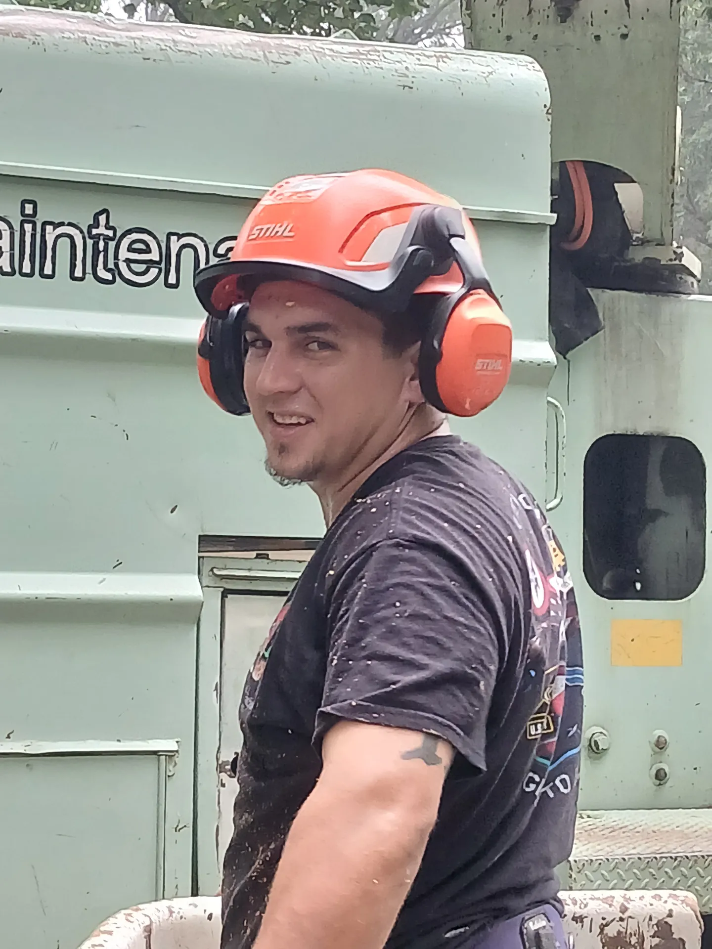 Portrait of a Clark's Tree Care arborist in Stihl helmet, on-site