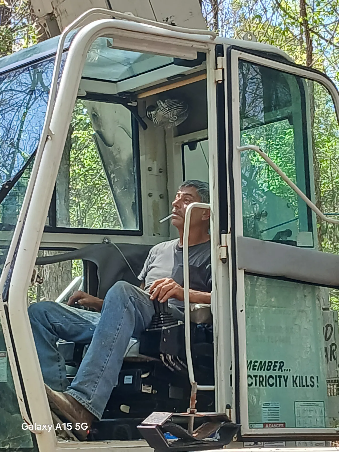 Operator at the controls of a tracked crane cab